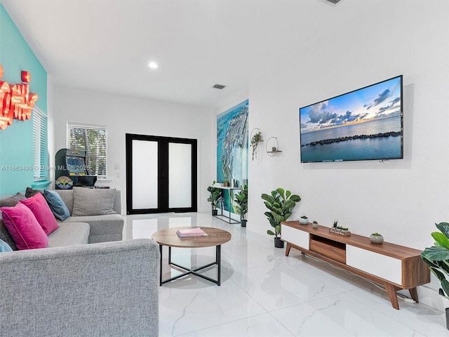 living area featuring marble finish floor, french doors, visible vents, and recessed lighting