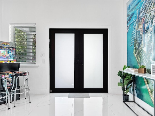 interior space featuring french doors and baseboards