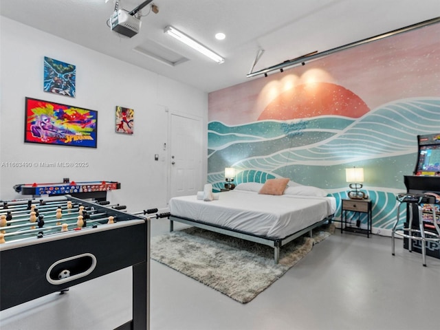 bedroom featuring a garage and finished concrete floors