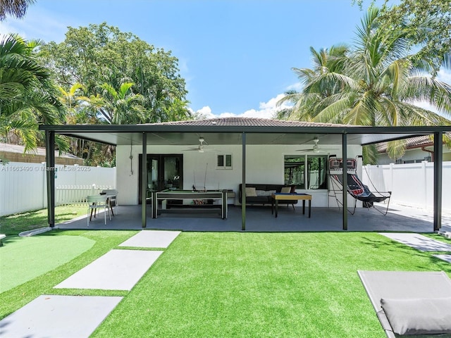 rear view of house featuring outdoor lounge area, a lawn, a patio area, ceiling fan, and a fenced backyard