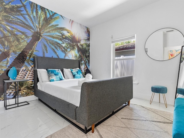 bedroom featuring marble finish floor and baseboards