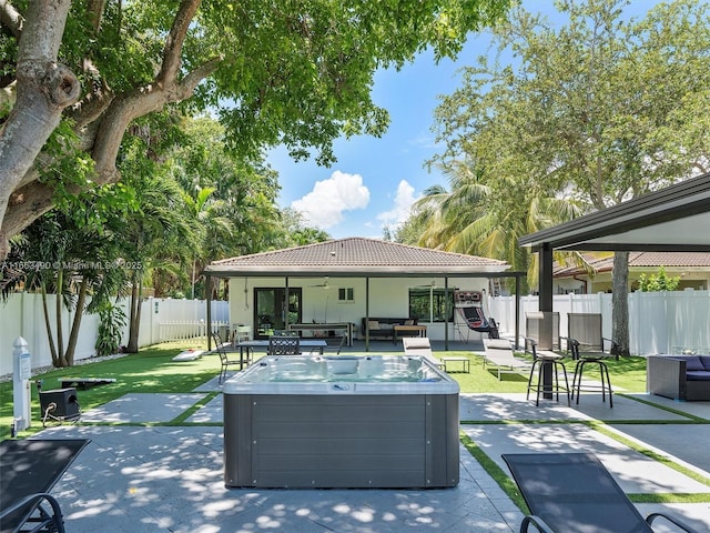 exterior space with a jacuzzi, a fenced backyard, an outdoor hangout area, a gazebo, and a patio area