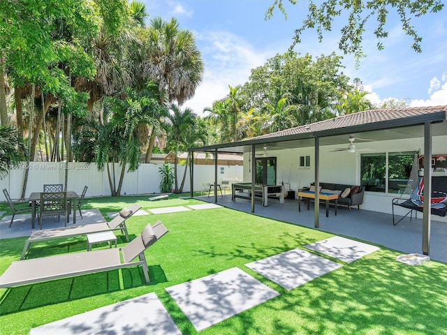 exterior space featuring a fenced backyard, outdoor lounge area, a lawn, and a patio