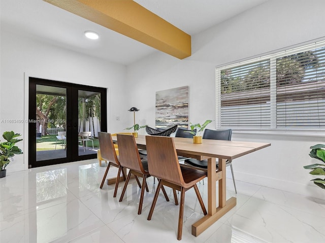 dining space featuring marble finish floor, a healthy amount of sunlight, baseboards, and french doors