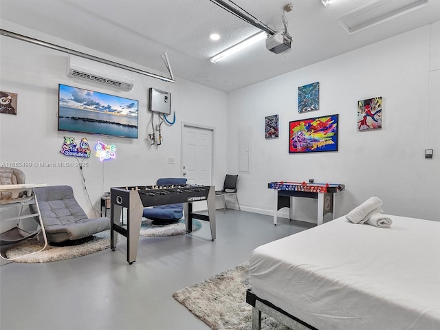 bedroom with a garage, a wall mounted air conditioner, electric panel, concrete floors, and baseboards