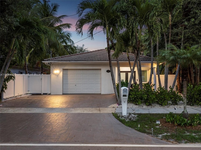 mediterranean / spanish house featuring a garage