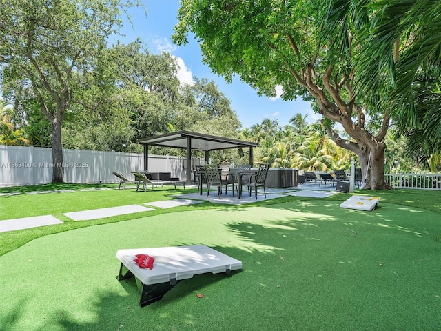 view of home's community with a yard, fence, a gazebo, and a patio