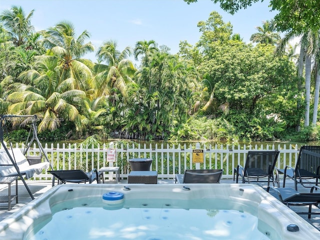 view of swimming pool featuring a hot tub