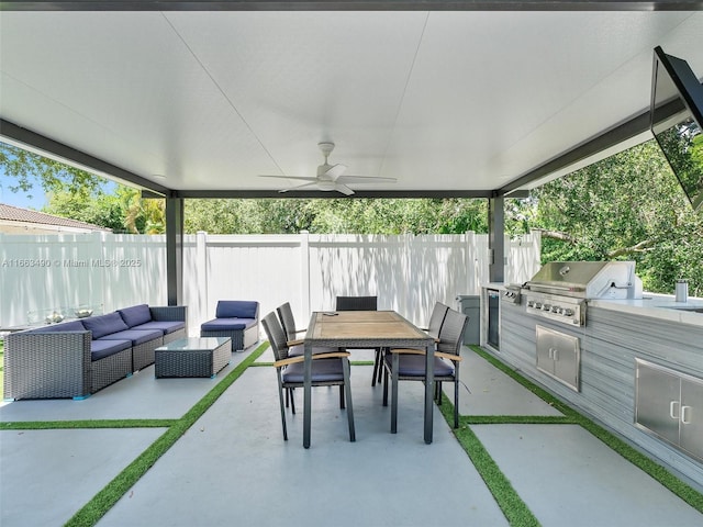 view of patio with outdoor dining area, grilling area, an outdoor kitchen, a ceiling fan, and a fenced backyard