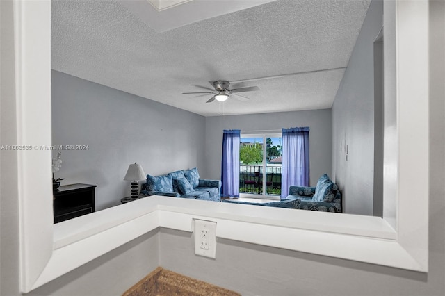 interior space featuring a textured ceiling and ceiling fan