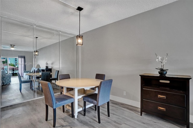 dining area featuring ceiling fan, a textured ceiling, and light hardwood / wood-style flooring