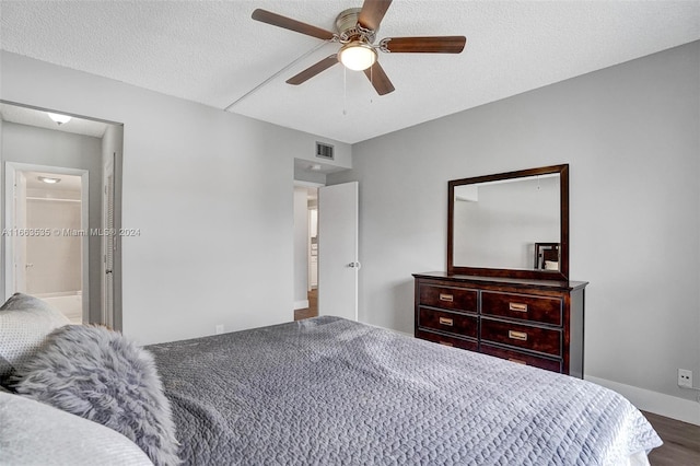 bedroom featuring a textured ceiling, ceiling fan, and wood-type flooring