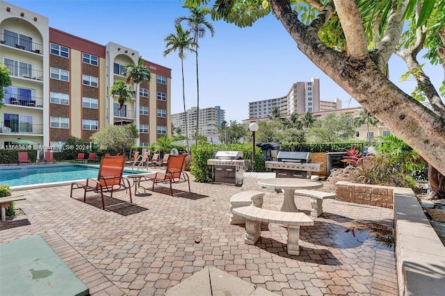 view of patio with a community pool and grilling area