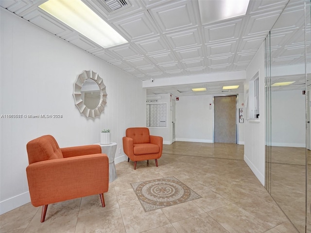 sitting room featuring light tile patterned flooring and elevator