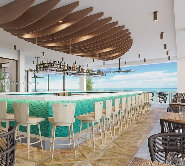 bar featuring parquet flooring and a water view