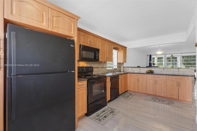 kitchen featuring plenty of natural light, sink, tasteful backsplash, and black appliances