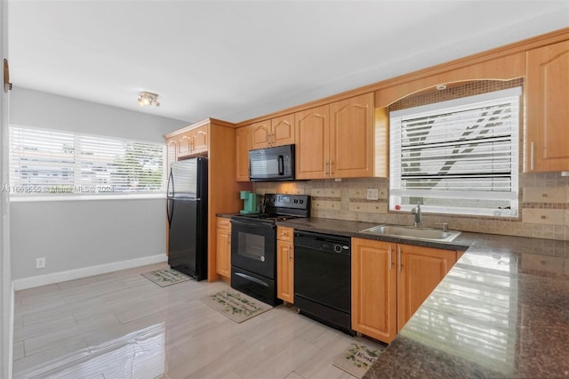 kitchen with black appliances, light hardwood / wood-style floors, sink, and tasteful backsplash