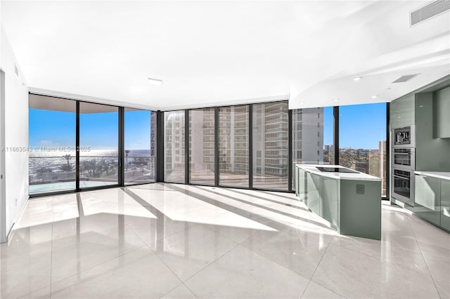 interior space featuring light tile patterned flooring and a wall of windows