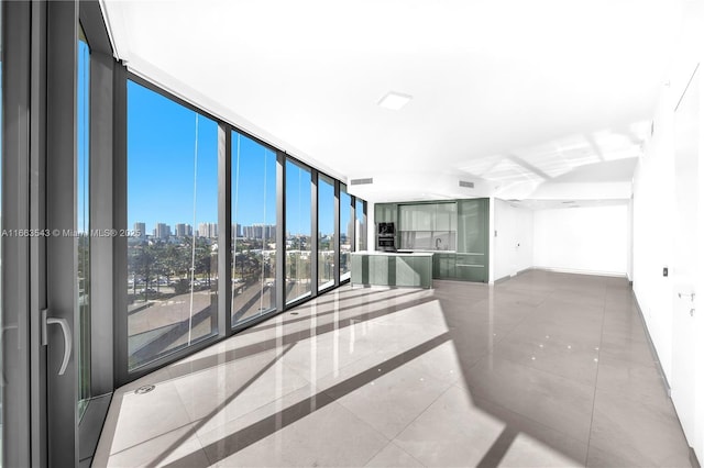 hall with tile patterned flooring and expansive windows