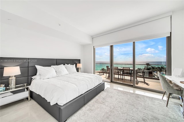 bedroom with access to outside and a water view