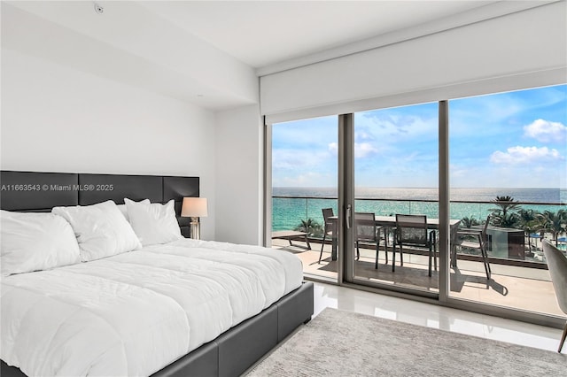 bedroom with access to exterior and a water view