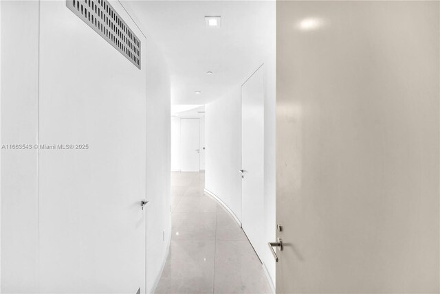 corridor with light tile patterned floors