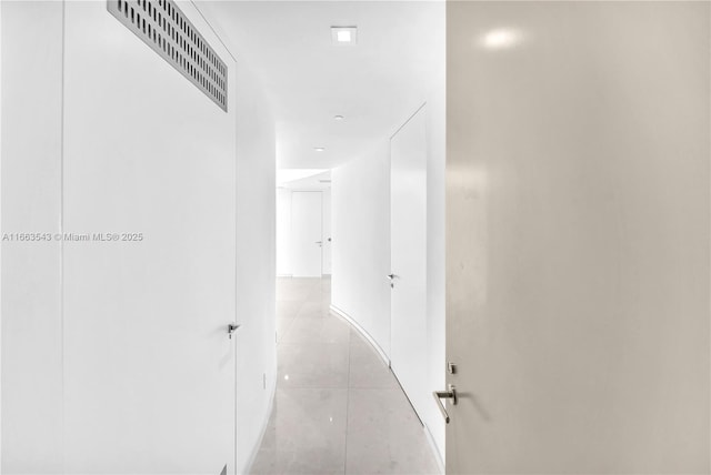 hallway featuring light tile patterned floors