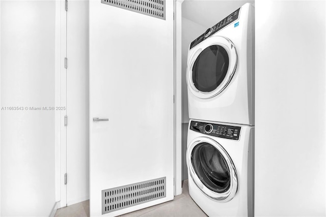 clothes washing area with stacked washer and clothes dryer