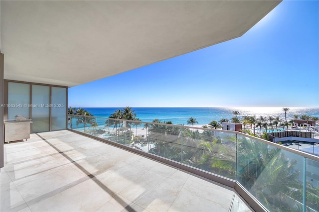 balcony featuring a water view and a view of the beach