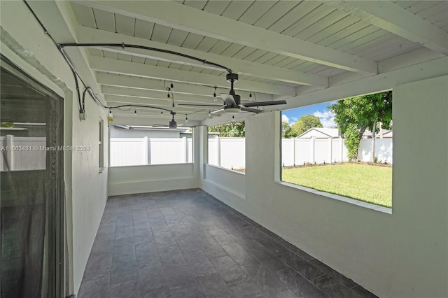 unfurnished sunroom with wood ceiling and beamed ceiling