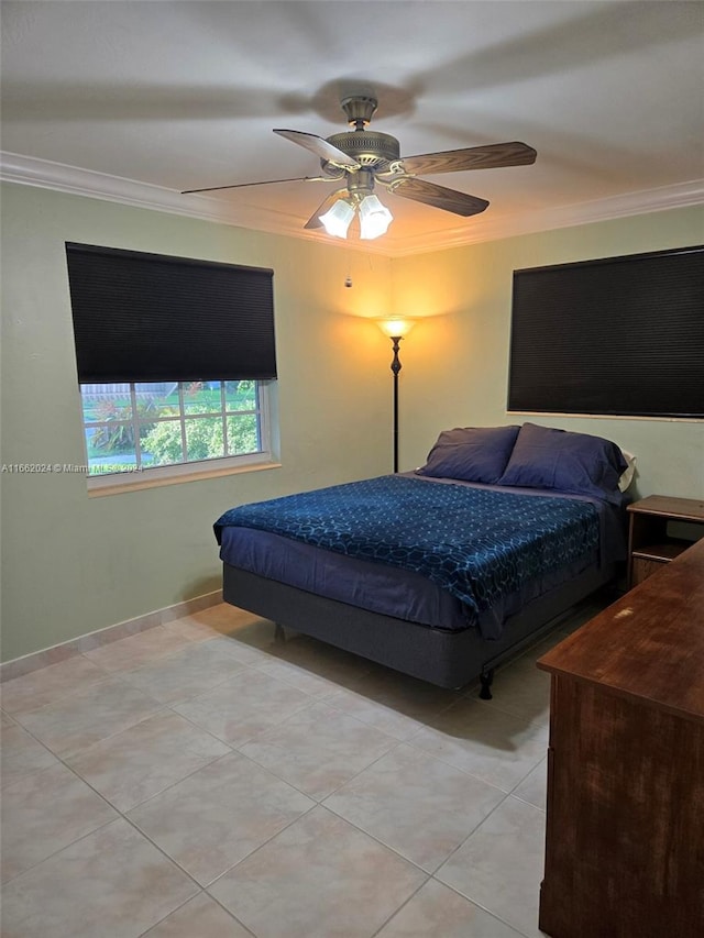 tiled bedroom with ceiling fan and crown molding