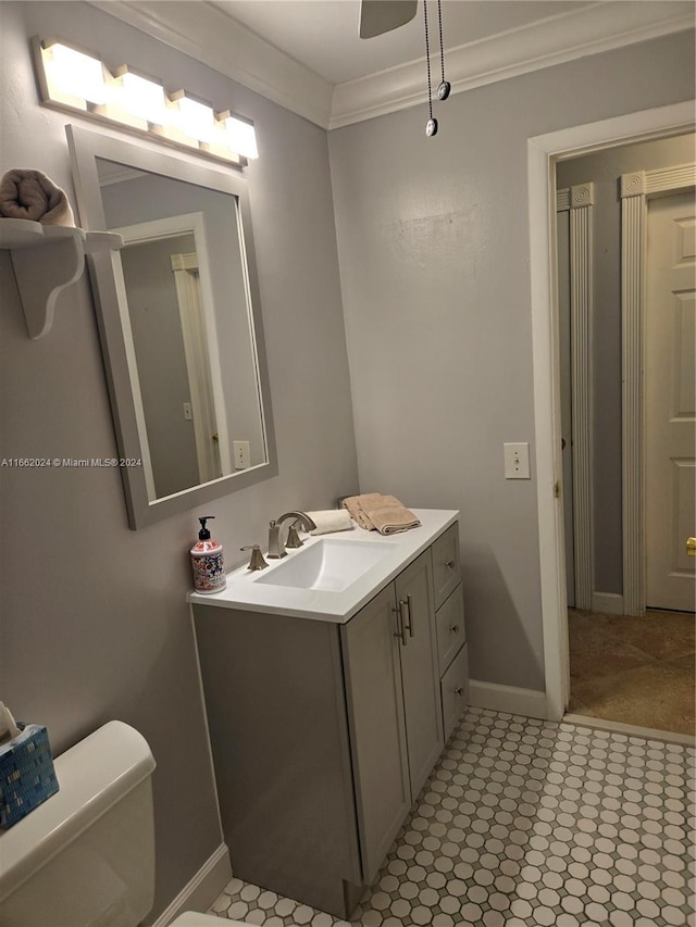 bathroom featuring vanity, toilet, crown molding, and ceiling fan