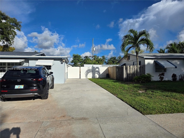 view of side of property with a lawn