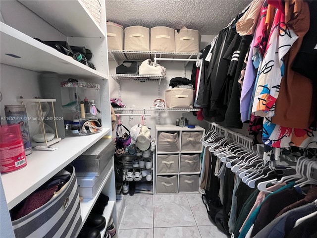 spacious closet featuring light tile patterned flooring