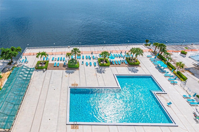 view of swimming pool with a water view