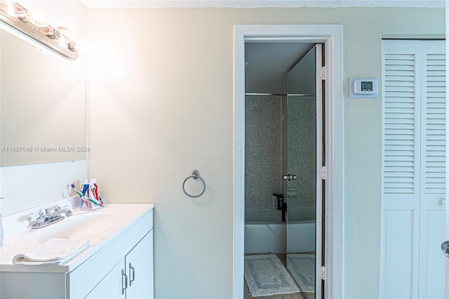 bathroom with vanity and bath / shower combo with glass door