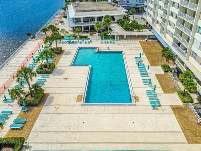 view of swimming pool with a water view and a patio area