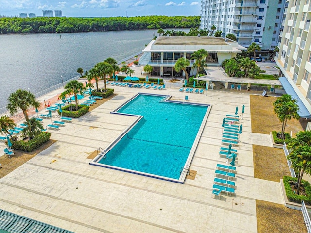 view of pool featuring a patio and a water view