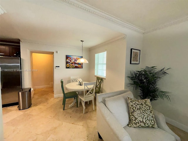 dining space featuring crown molding