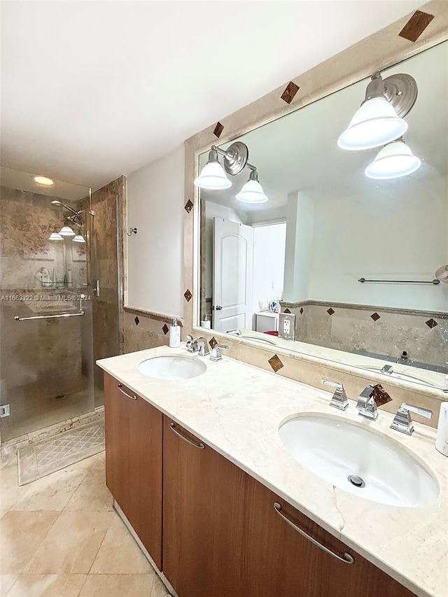 bathroom featuring a shower with door, vanity, and tile patterned floors