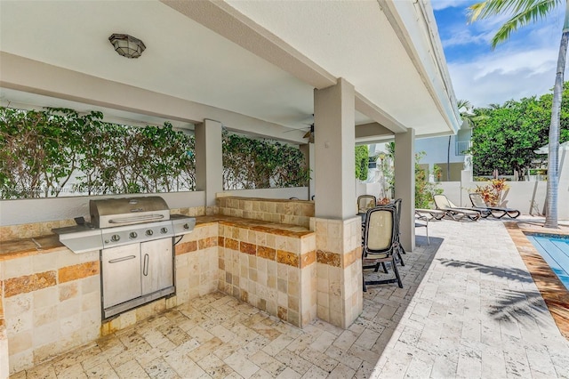 view of patio / terrace with area for grilling and ceiling fan