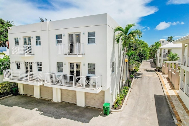 view of front of home featuring a balcony and a garage