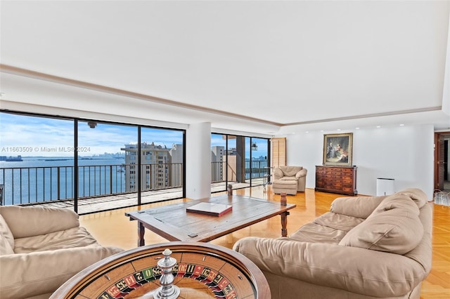 living room with a water view and light parquet flooring