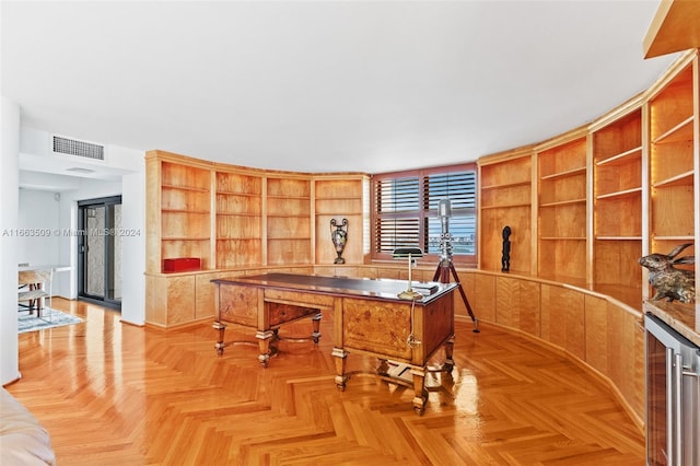 office area with built in features, wine cooler, and light parquet floors