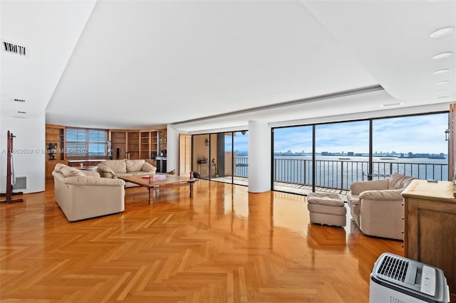 living room featuring a water view and light parquet floors