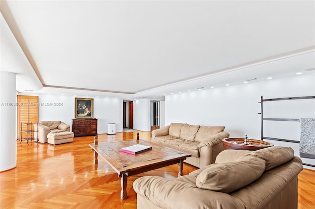 living room with a tray ceiling and light parquet floors