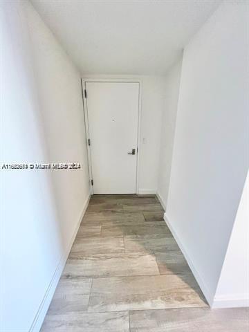 45 SW 9th St Unit 3009, Miami, FL 33130 - hall with baseboards and light wood-type flooring
