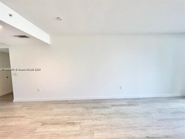 unfurnished room with light hardwood / wood-style flooring