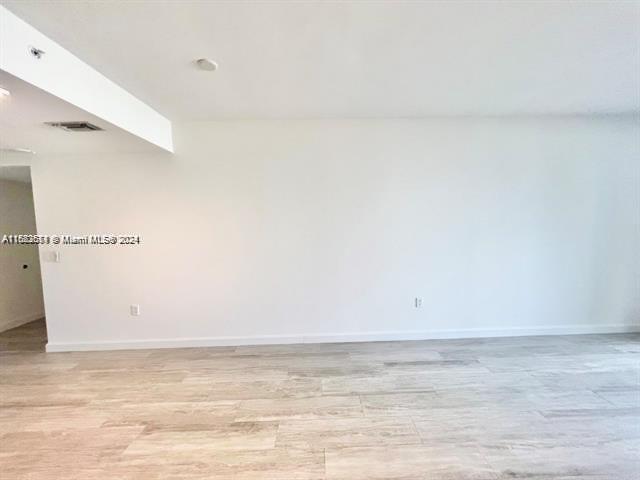 45 SW 9th St Unit 3009, Miami, FL 33130 - spare room featuring baseboards and light wood-type flooring