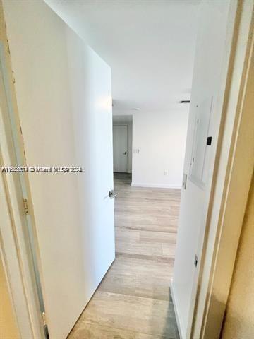 45 SW 9th St Unit 3009, Miami, FL 33130 - hall featuring light wood finished floors, electric panel, and baseboards